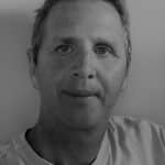 Portrait of a man with short hair in grayscale.