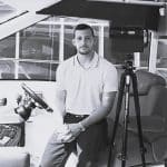 Man operating 3D laser scanner in an indoor environment.
