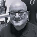 Portrait of Steve S. wearing glasses in an office setting.