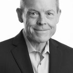 Black and white portrait of a middle-aged man in a suit.