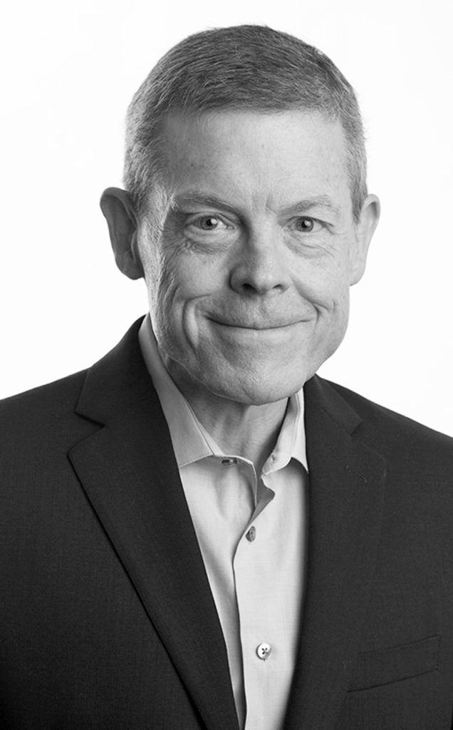Black and white portrait of a middle-aged man in a suit.