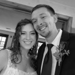 Smiling bride and groom at wedding celebration.