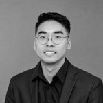 Portrait of Vincent Z., UAV expert, wearing glasses and a suit.