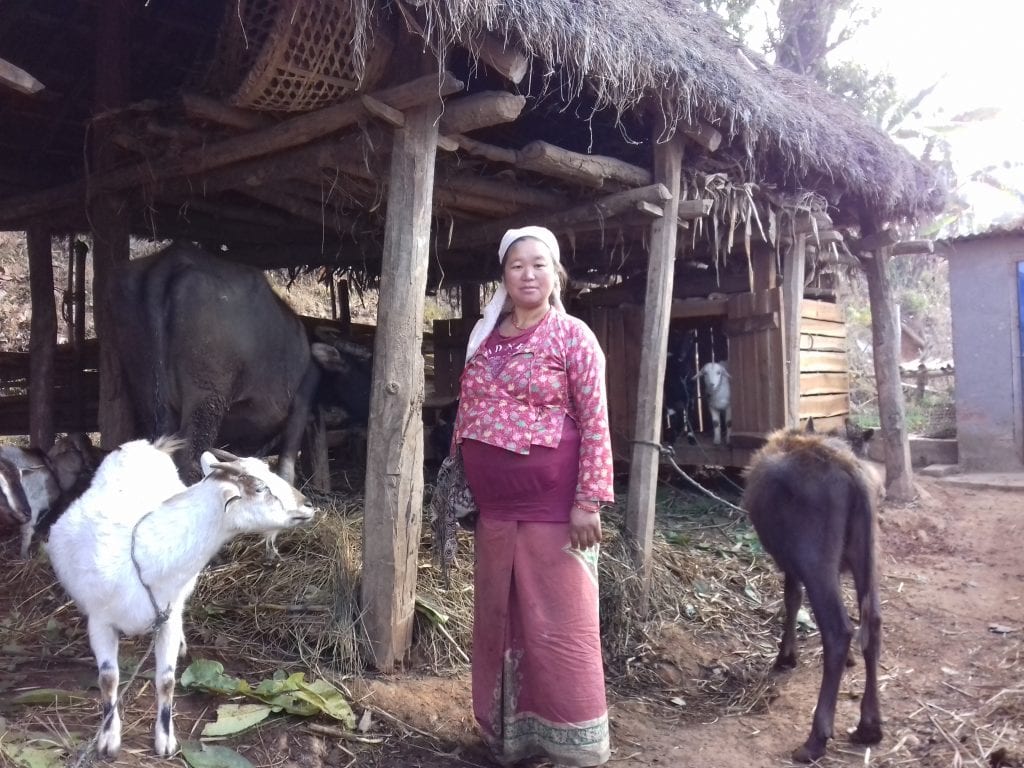 Huma Kamari standing in front of a building with her animals.