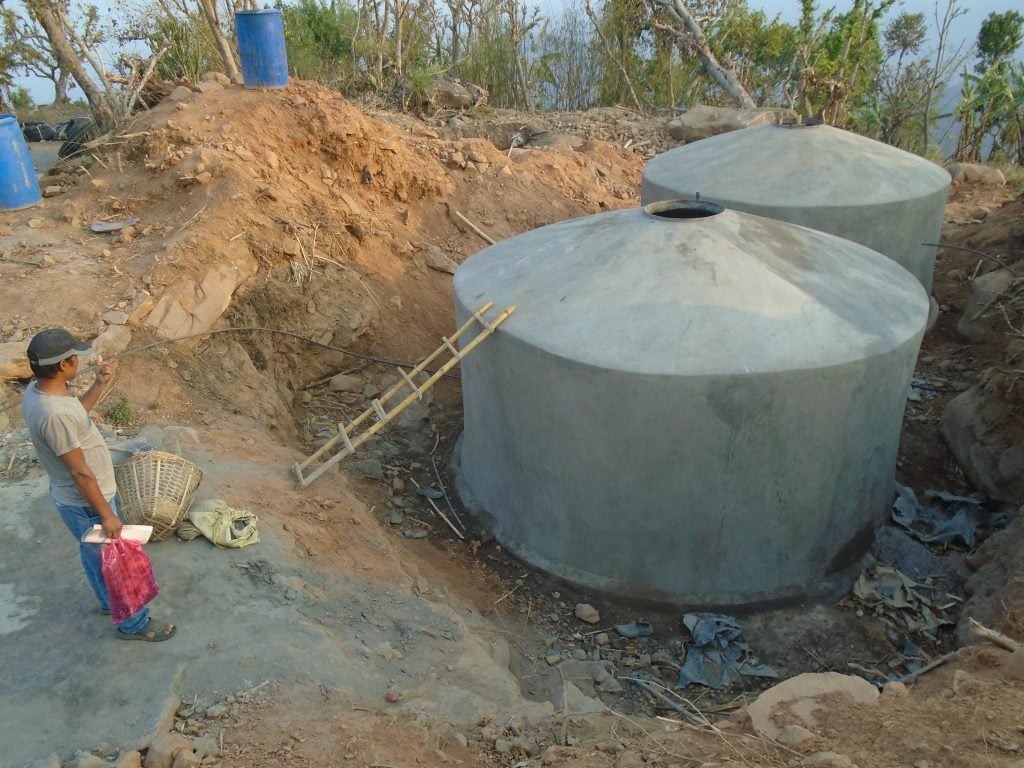 View of two large concrete water storage tanks under construction