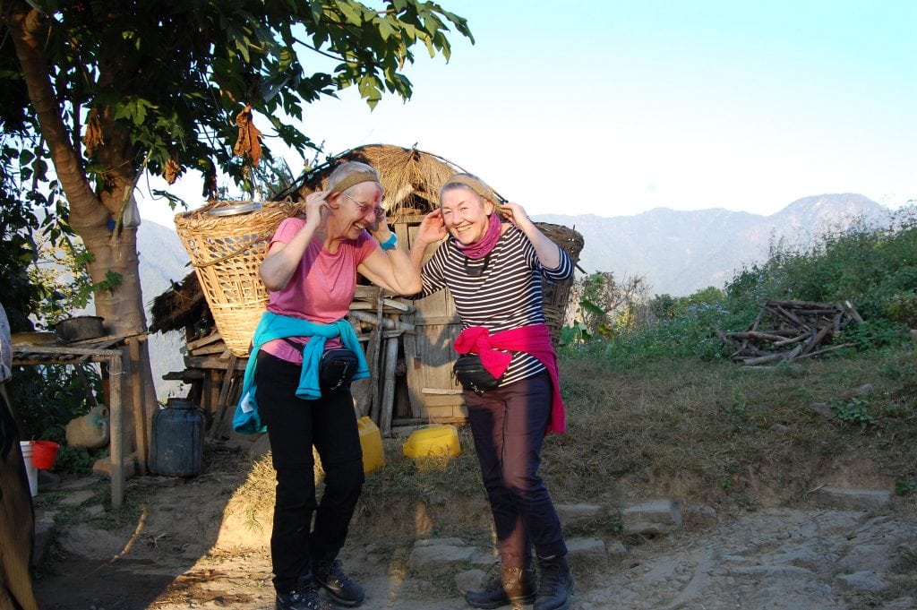 Sue and Elaine fetch water from the source and take it to the community. 