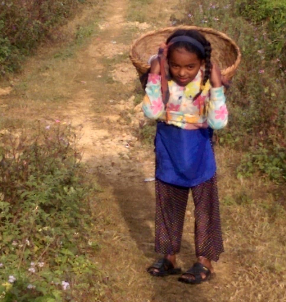 A Nepalese child carries water.