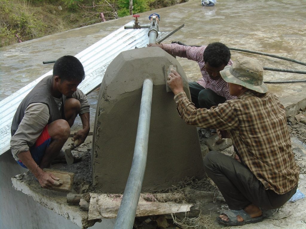 Community members begin to install piping for the solar-powered pump