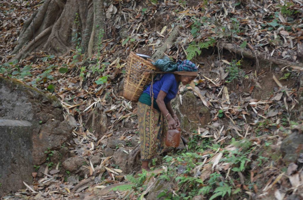 A Nepali woman carrying a gagri (a traditional water vessel)