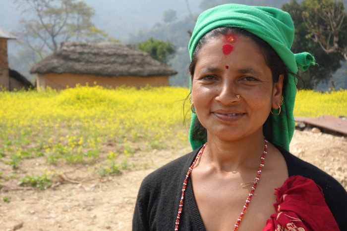 Kamala Pangeni standing in front of a field.