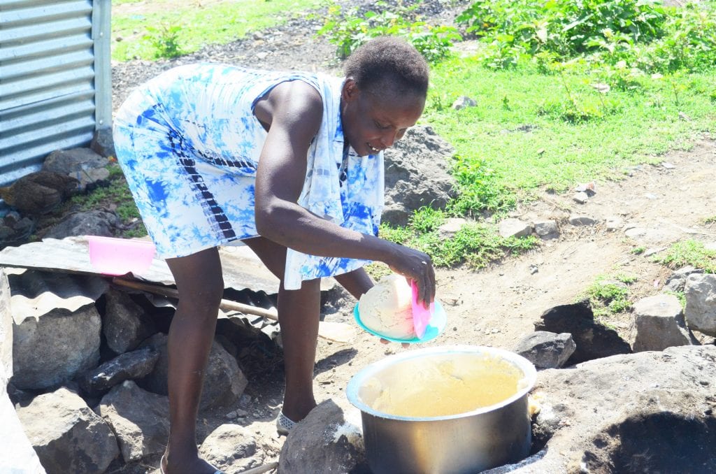 Lillian preparing food outside