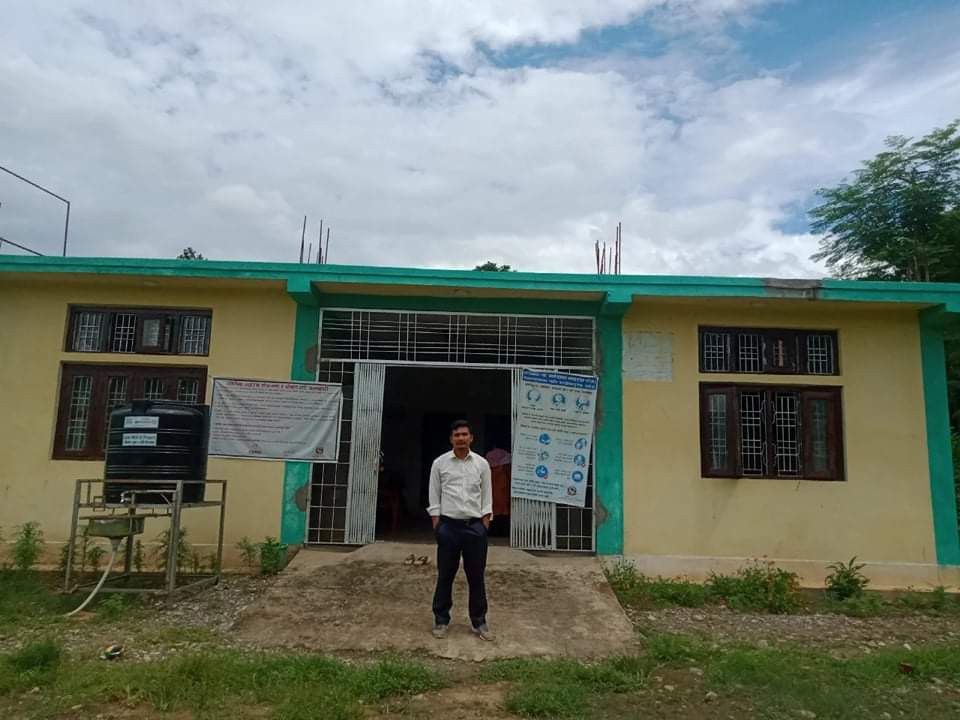 Bhuwan Poudel stands in front of Chepang Health Post