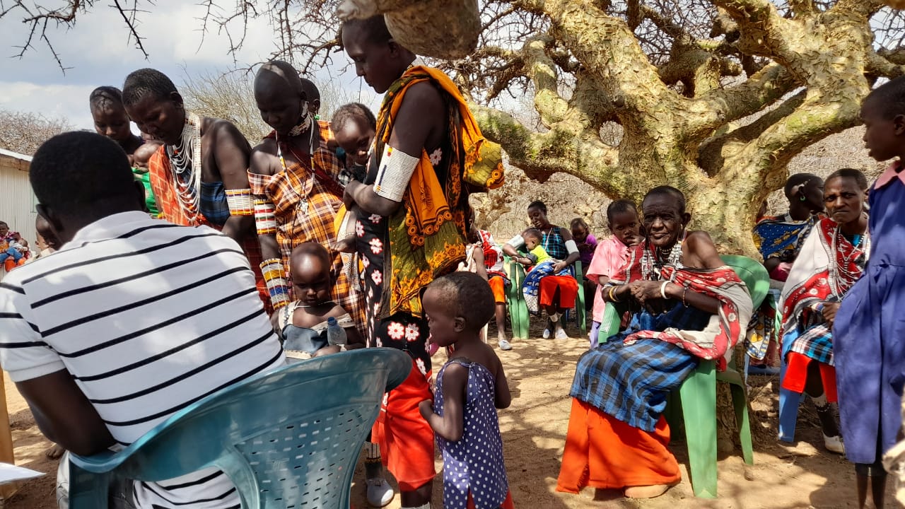 A group of Maasai people attending a health awareness raising session at Enkoreroi clinic in Kenya