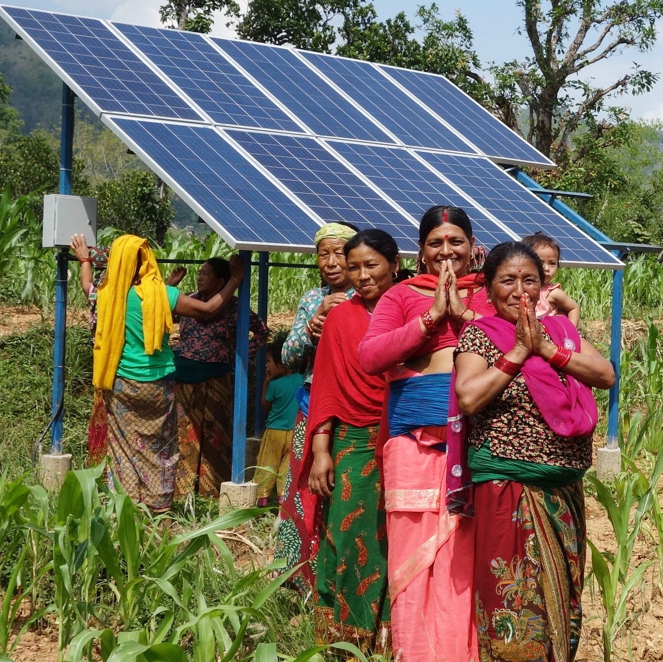 Nepalese ladies in front of solar panel