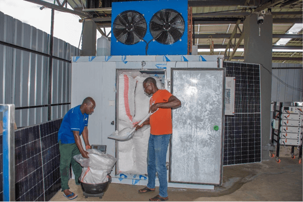 Ice-plant-operators-filling-a-sack-of-ice