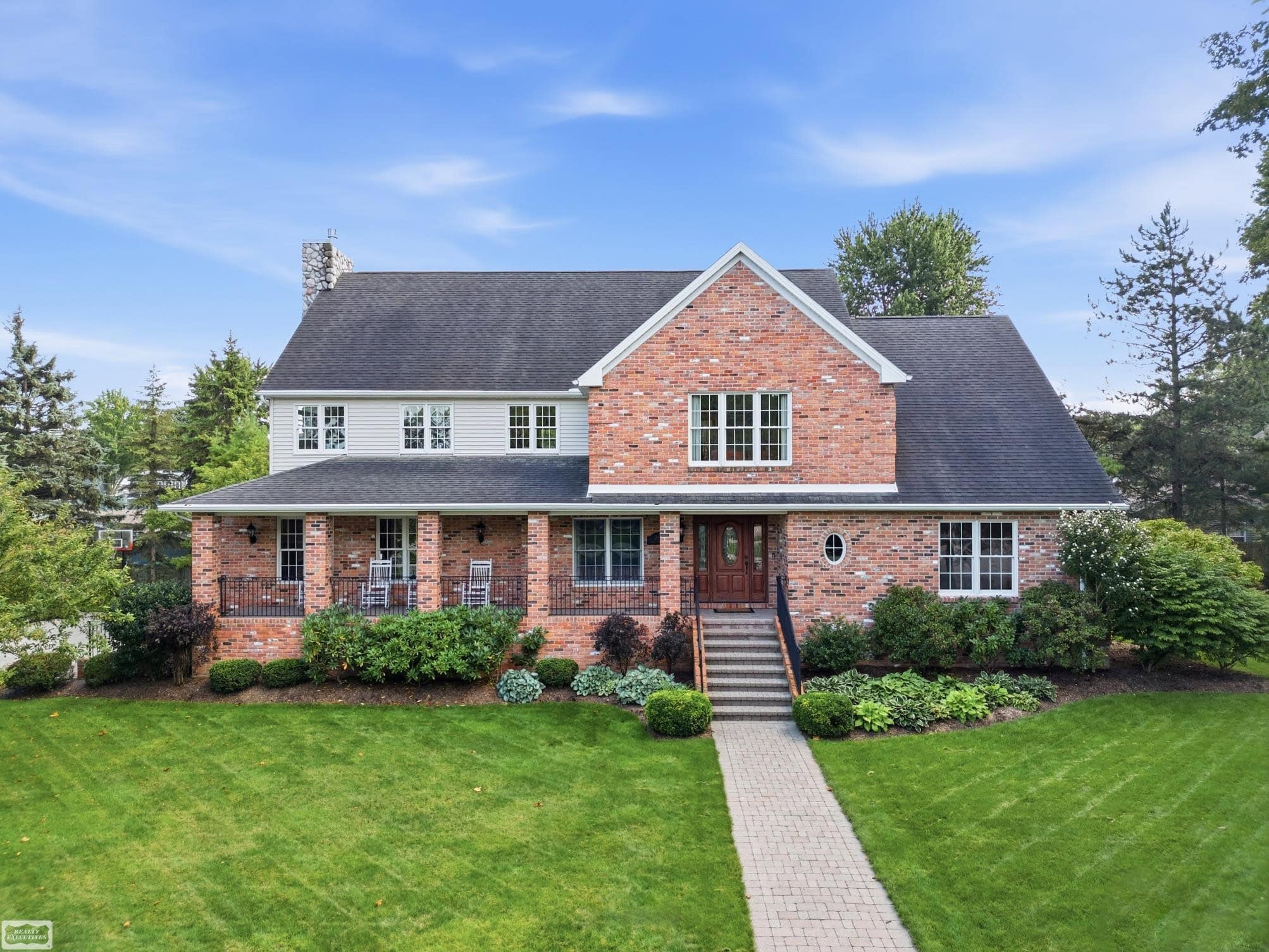 Lake Huron living at its best! Enjoy beautiful water views and a private neighborhood with beach access and pickleball/tennis court. Impressive paverstone front porch w/ custom wrought iron railings invite you into this custom home designed for entertaining, featuring a spacious open Great Room with hickory kitchen, dining area, walk-in pantry, hardwood floors, and dramatic floor-to-ceiling cultured stone fireplace with wonderful views of the Lake.  Sun-filled sitting room with skylights and French doors opening to relaxing balcony. Two primary suites—one on each level—offer flexibility for guests or family. Finished daylight basement includes egress, bath, workroom, and abundant storage, with wide access from the garage. Oversized 2.5-car garage with storage above. Zoned heating/cooling and quality solid-wood doors and trim. Exceptional landscape and peaceful paverstone patio complete this exceptional waterfront lifestyle home.