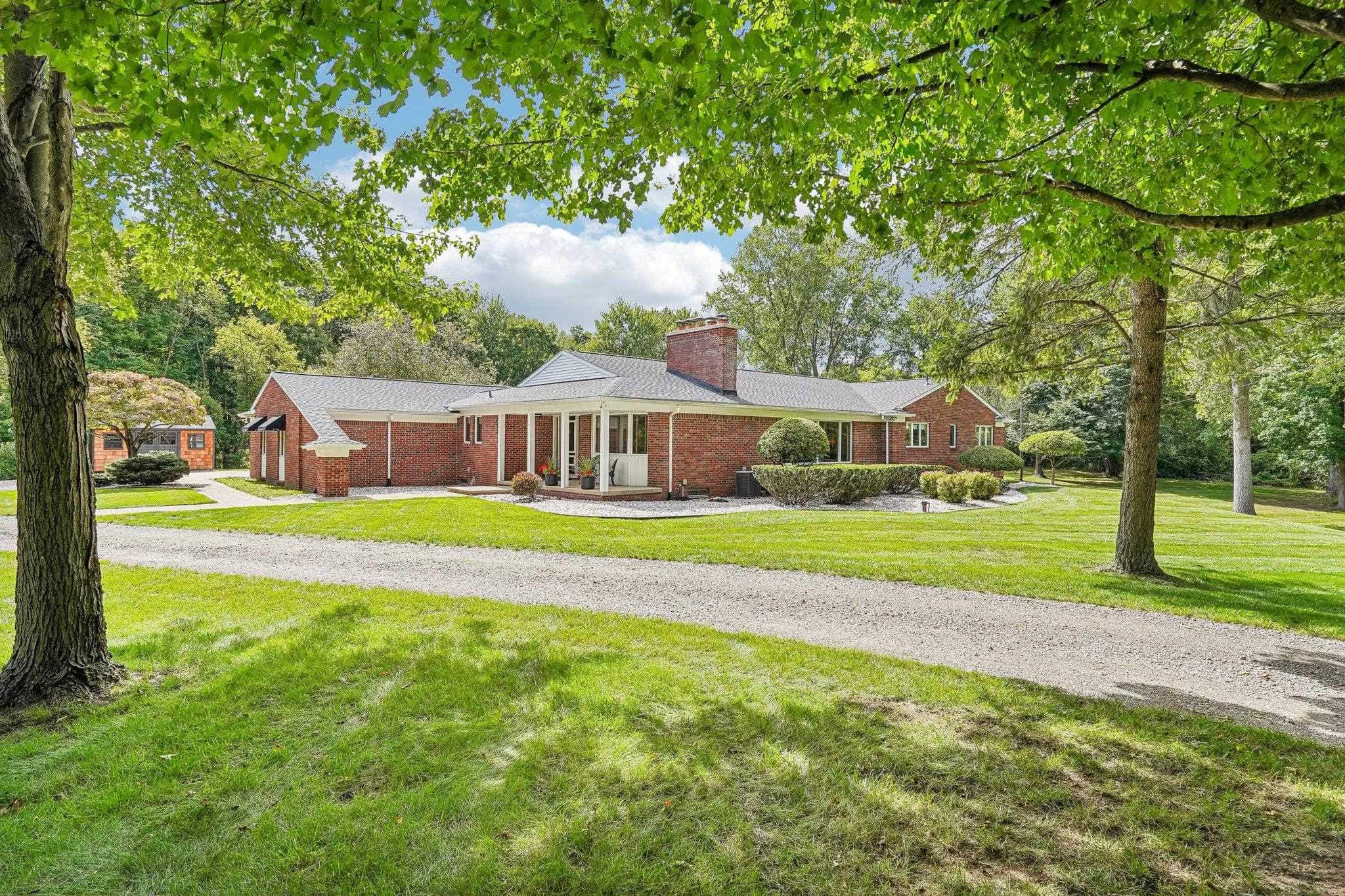 Rare and hard-to-find brick ranch on 3.82 acres in Oakland Township in a beautiful wooded setting. Approximately 2,665 sq. ft. on the main level plus 2,500 sq. ft. of finished walkout basement. The home offers 4 bedrooms, 3.5 baths, two fireplaces, multiple living and entertaining areas, and an attached 3-car garage. The lower level includes an additional bedroom and bath, billiard room, recreation space, wet bar, canning kitchen, and direct access to the backyard. Large patio overlooks the wooded property and mature trees. The pond and surrounding natural habitat attract a variety of wildlife. New in 2026: complete roof replacement including new decking and 50-year shingles, interior paint, water softener, well pressure tank, water filtration system, sump pump with alarm and backup system, and 12x16 shed. Conveniently located near Rochester, Lake Orion, Romeo, shopping, dining, and major roads. An opportunity for the next owner to update to their own style and preferences. Seller is a licensed real estate salesperson in the State of Michigan.