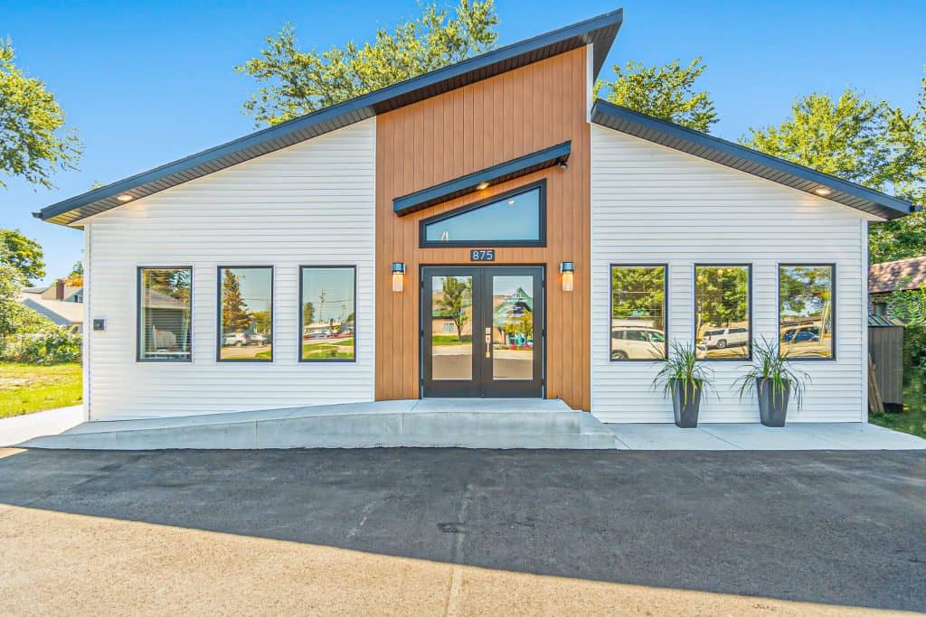 Modern residential house with contemporary design, clean lines, and large windows, located in West Michigan. Ideal for homebuyers seeking stylish, new construction homes in the West Michigan real estate market.