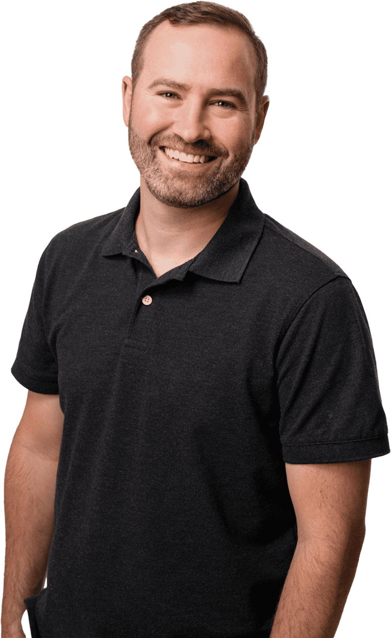 Beautiful smiling man in black polo shirt, standing confidently to promote real estate services in West Michigan.