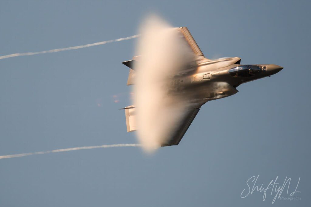 Aero jet flying at high speed, leaving vapor trail behind during flight.