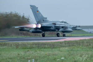 See You Later Aero fighter jet taking off with afterburners engaged on runway, showcasing military aviation skills and power.