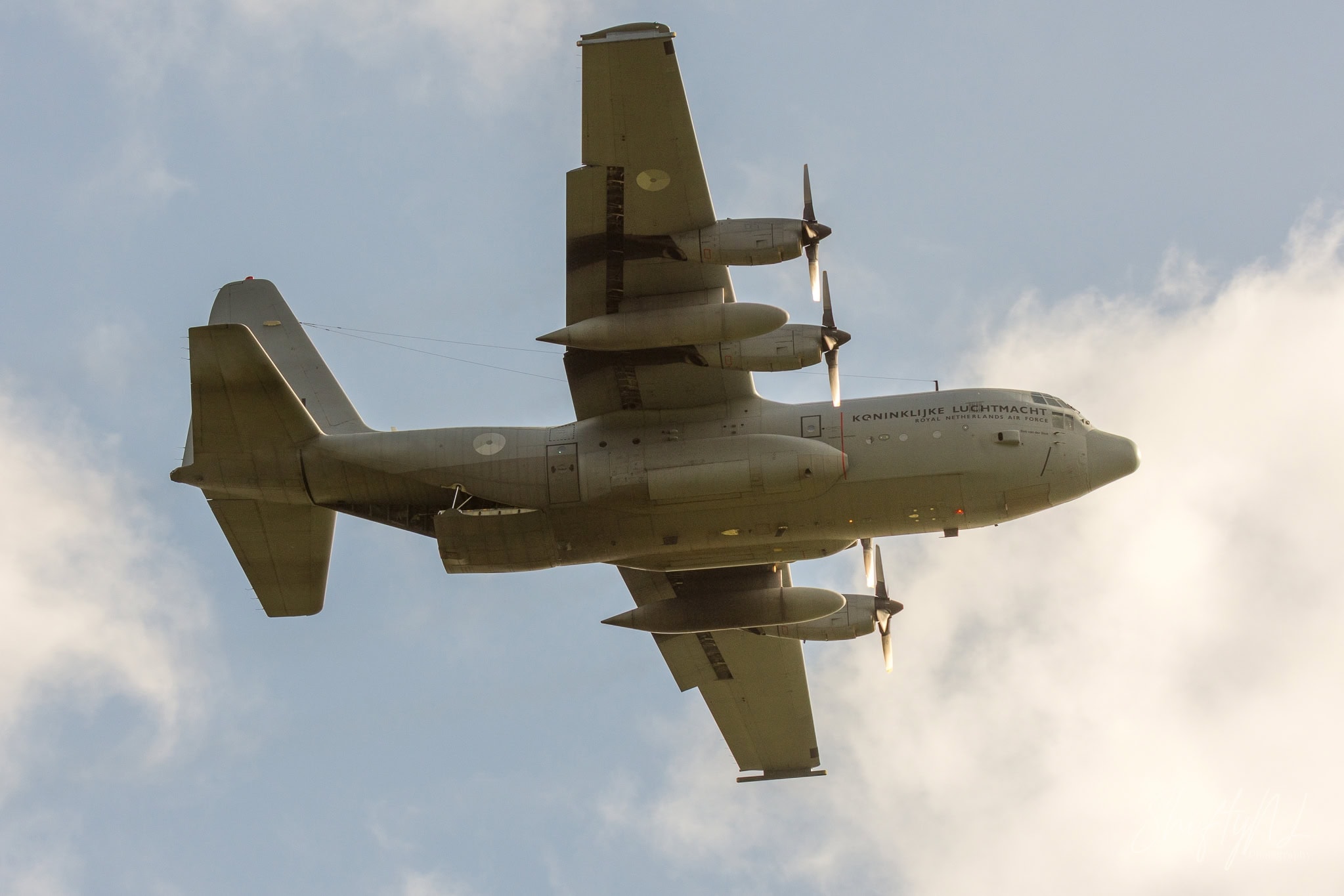 Royal Netherlands Air Force C-130 Hercules flying overhead against a blue sky at Deelen, during exercise Falcon Autumn, the Netherlands, October 2018.