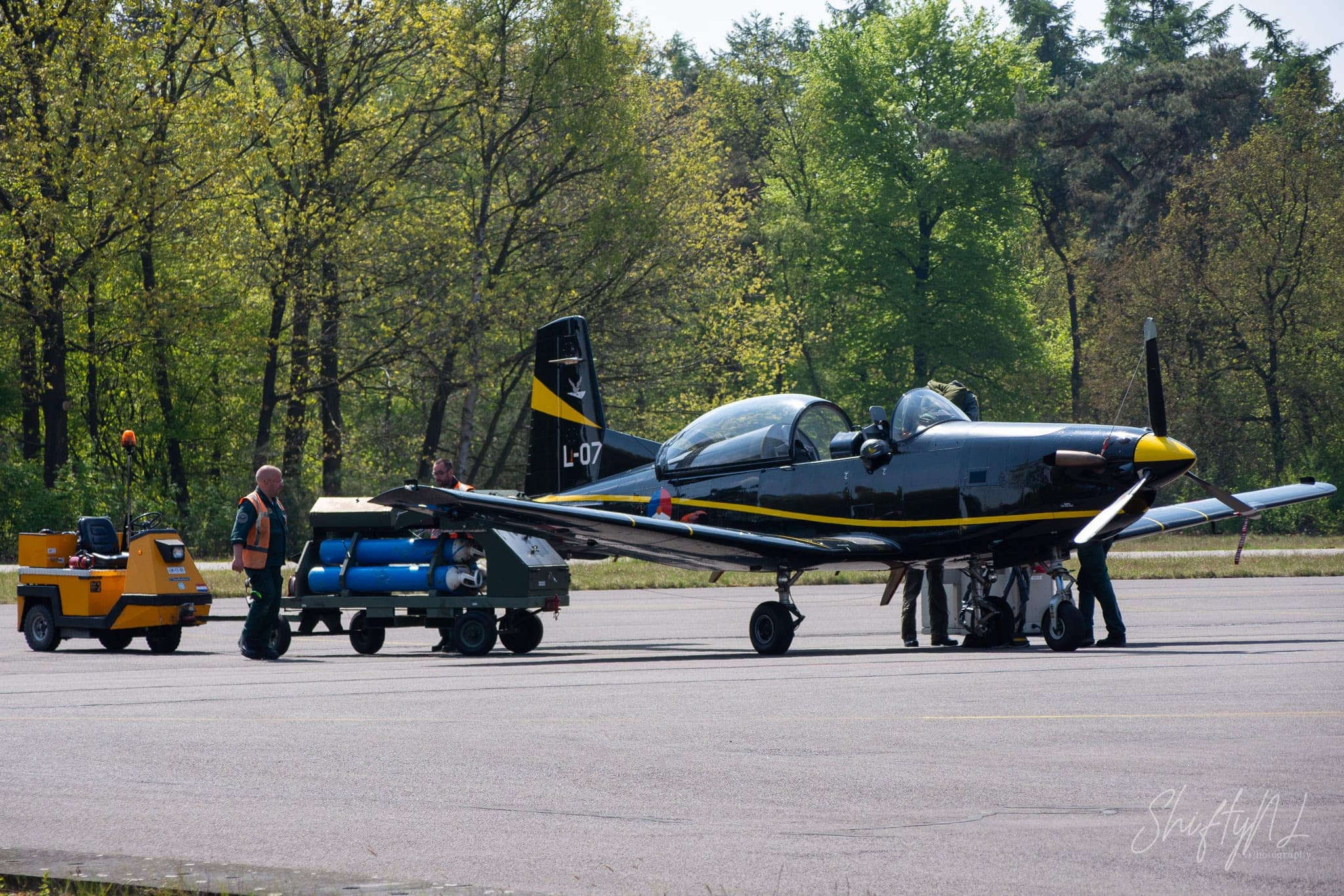 Black and yellow Pilatus PC-7 trainer of the Royal Netherlands Air Force with its pilot on board at Woensdrecht Air Base, the Netherlands, during a visit to 131 EMVO Squadron, May 2017.