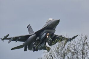 1. Advanced fighter jet soaring through the sky during a military airshow, showcasing aerial power and precision engineering.
