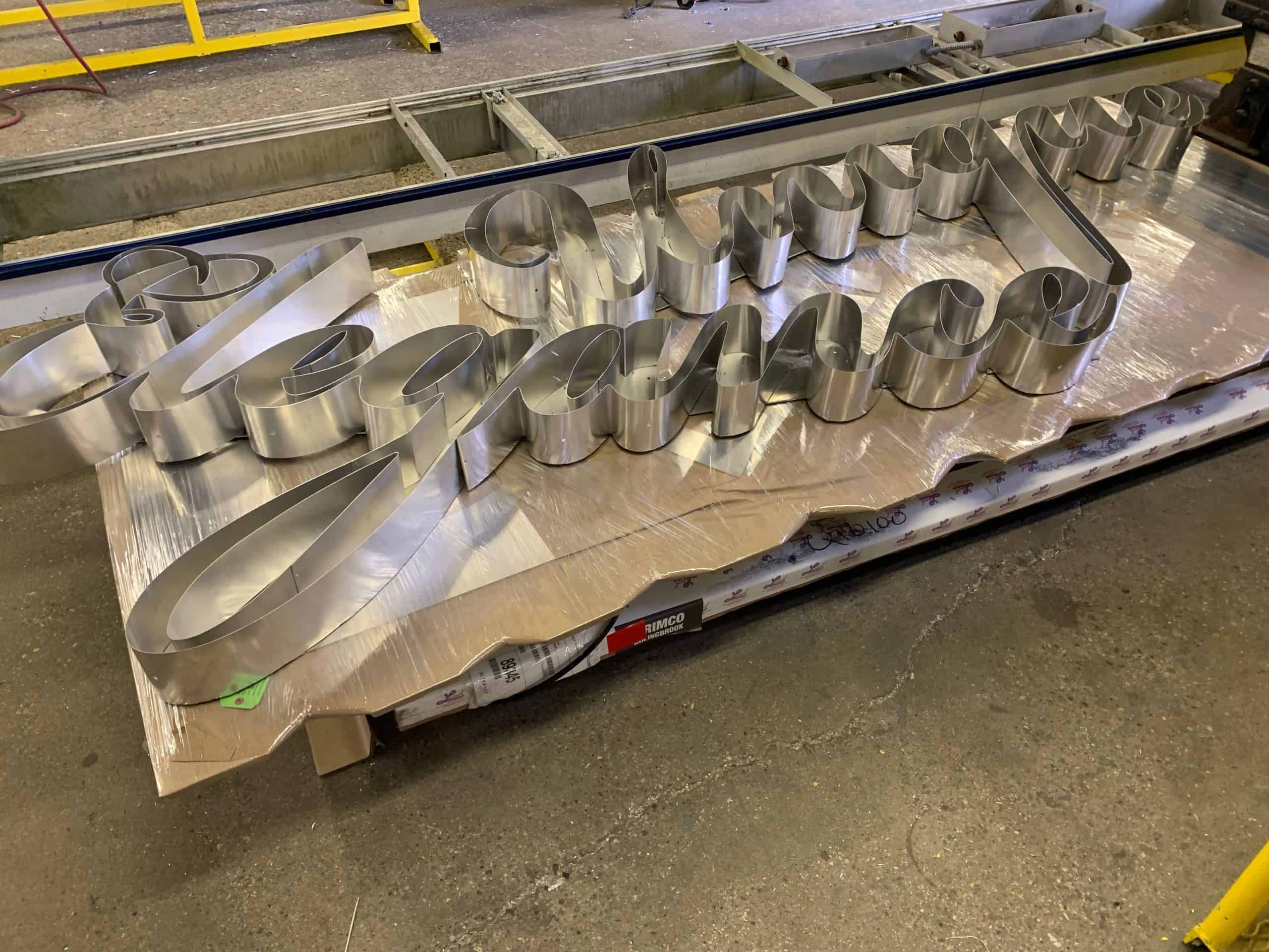 Metal signage for Rename Website with illuminated 3D text.