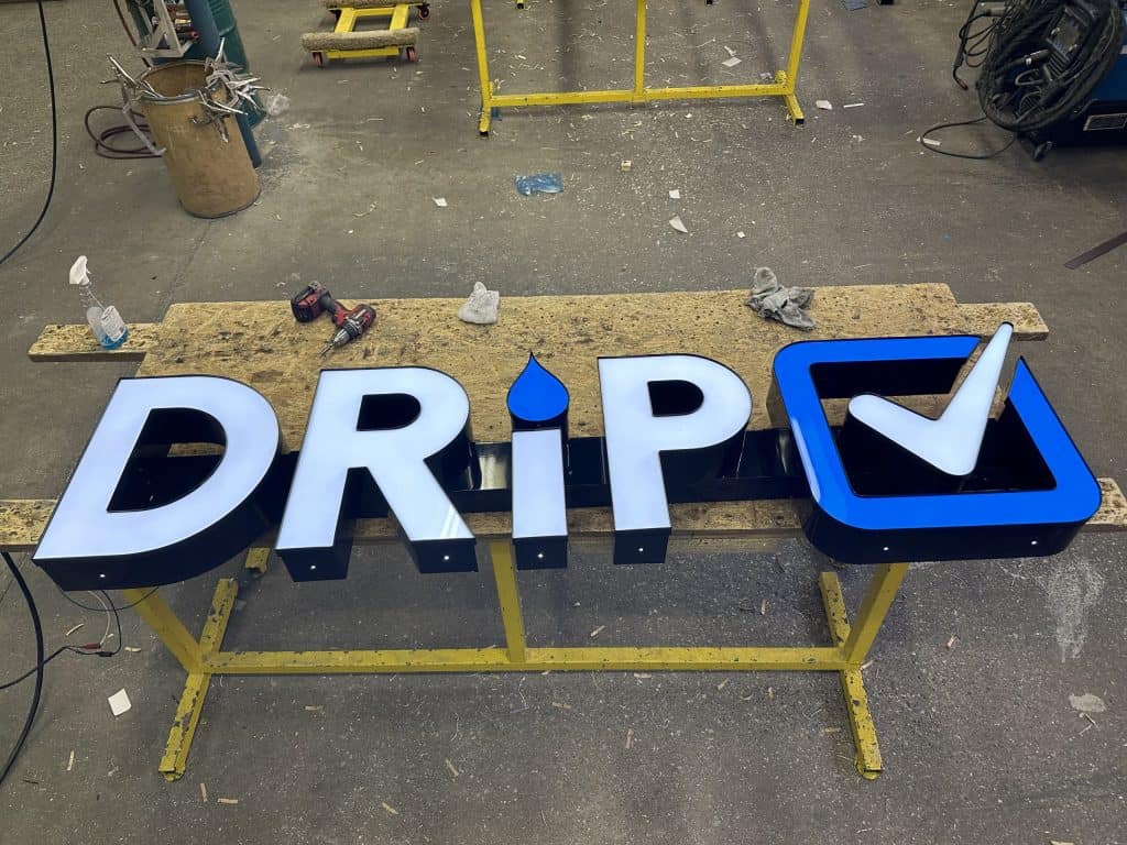 Custom illuminated sign for Rename Website with logo and text.