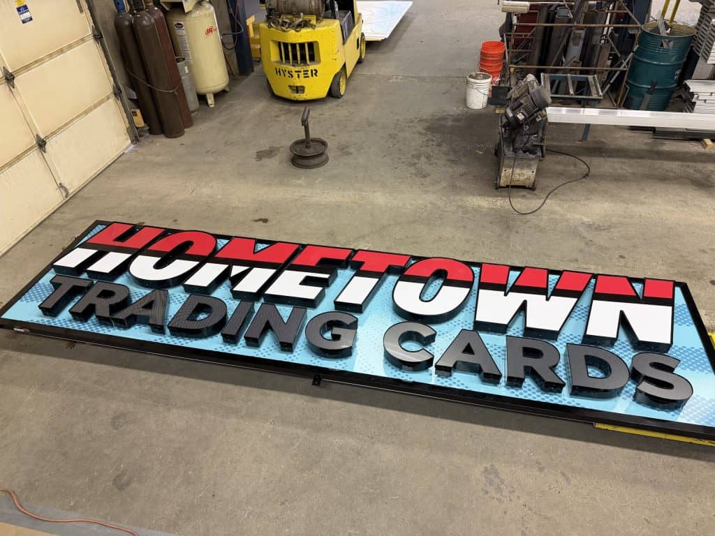 Custom sign reading 'Hometown Trading Cards' for website branding.