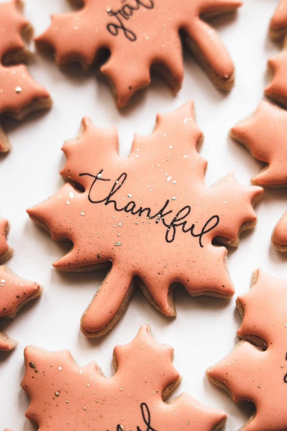 Maple leaf cookies with thankful message for bakery branding.