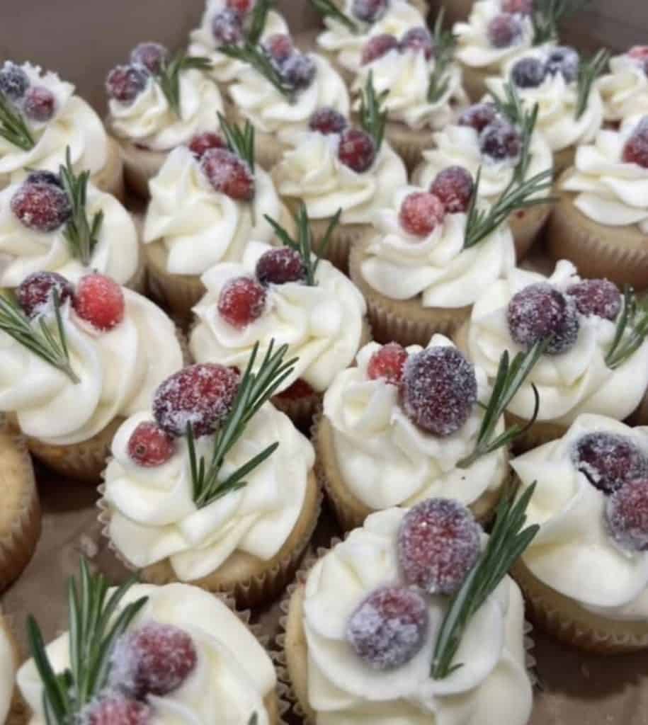 Delicious cupcakes topped with berries and rosemary from Smutz Girls Bakery.