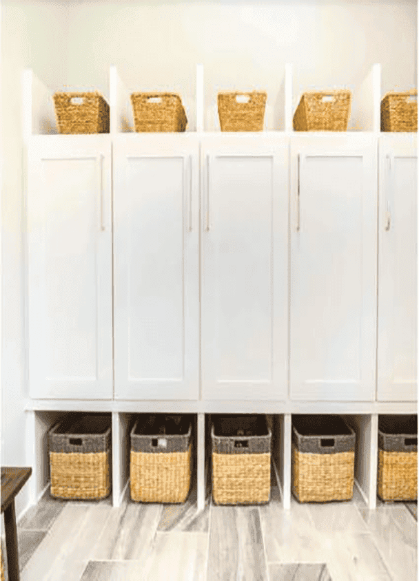 White storage cabinets with wicker baskets on top and bottom shelves.