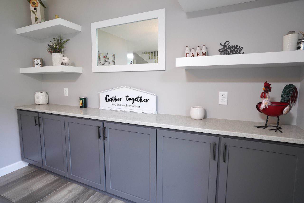 Contemporary kitchen with gray cabinets and white countertops.