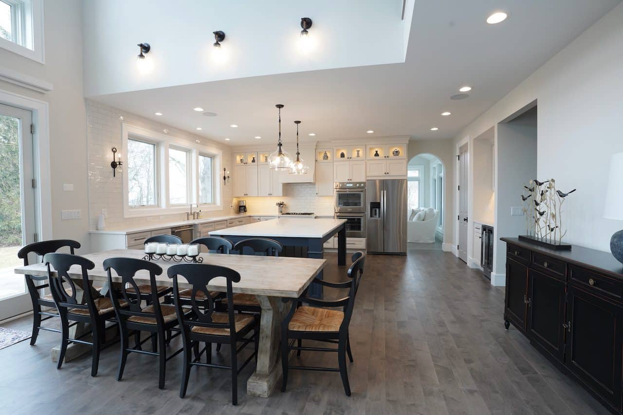 Spacious modern kitchen with island, dining table, and natural light.