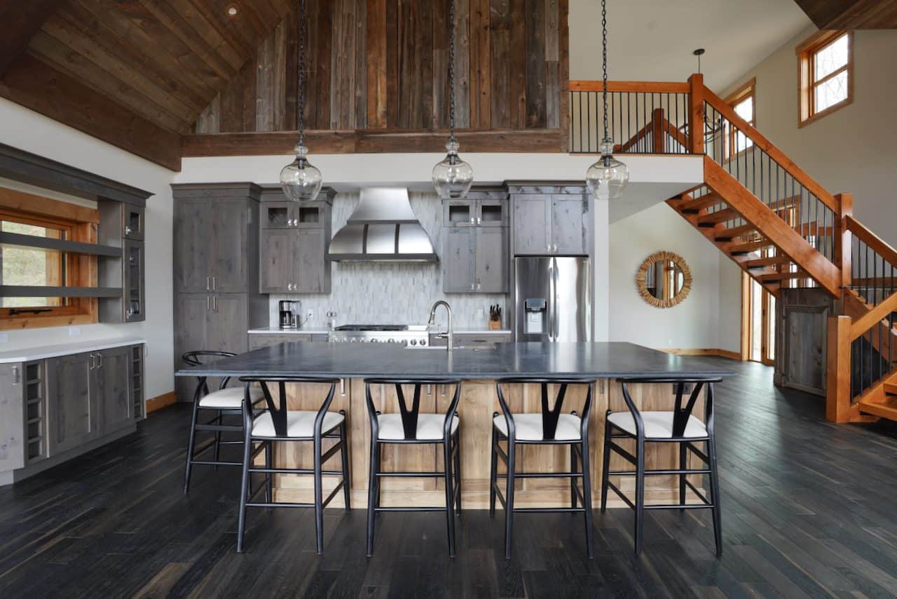 Contemporary kitchen with gray cabinetry, island, and wooden accents.