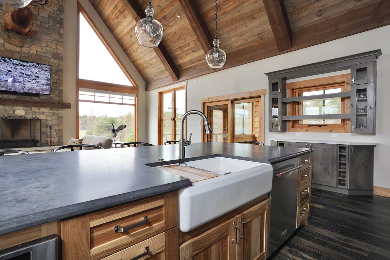 Open-concept kitchen with large island, farmhouse sink, and wooden accents.