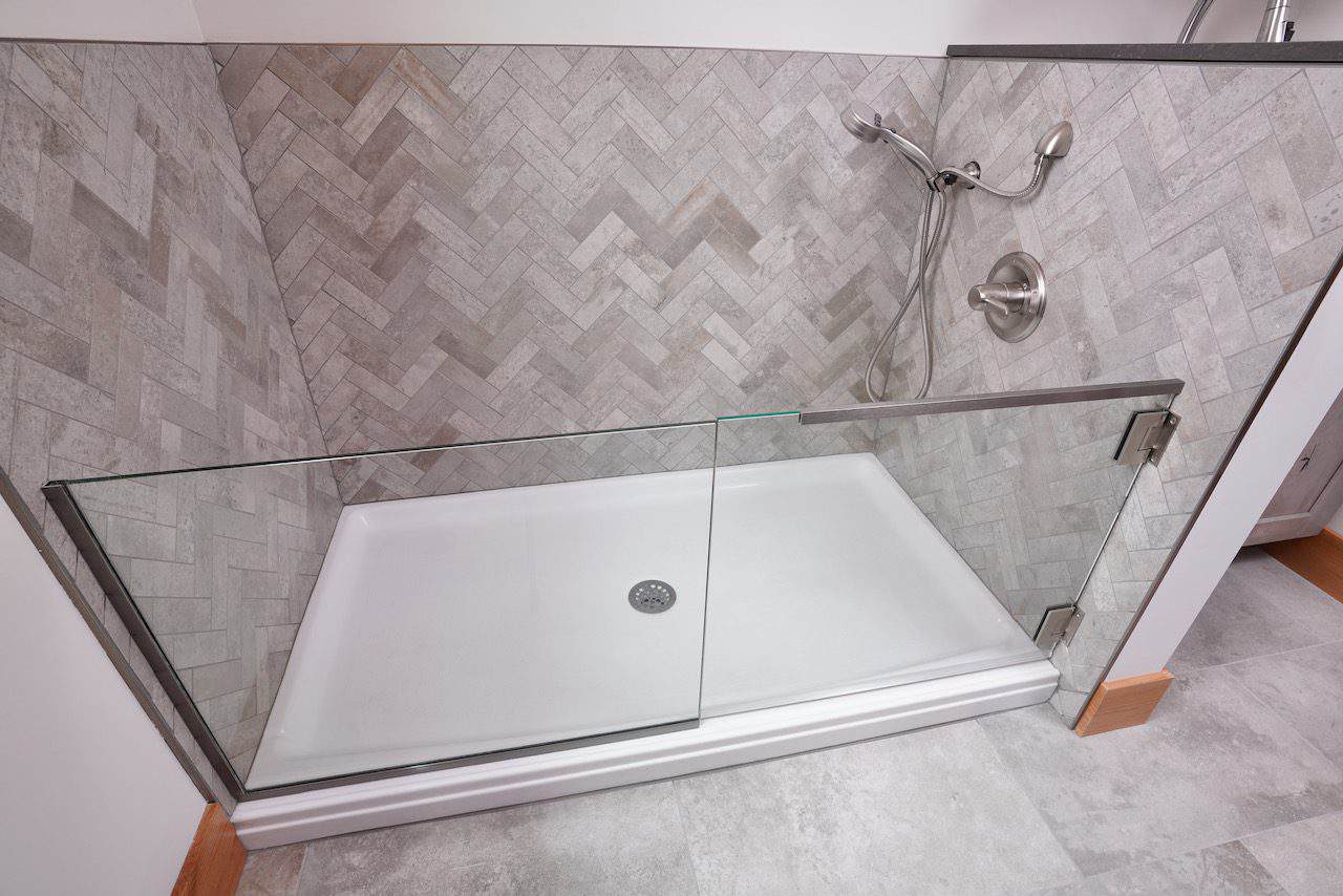 Contemporary shower with glass enclosure and wall-mounted showerhead.
