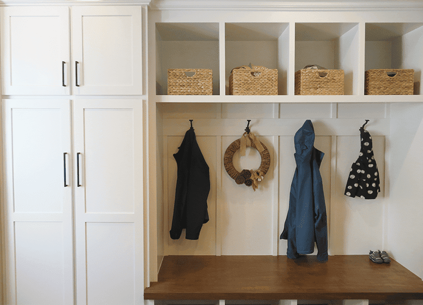 Mudroom with hooks, baskets, and coats for organized entryway.