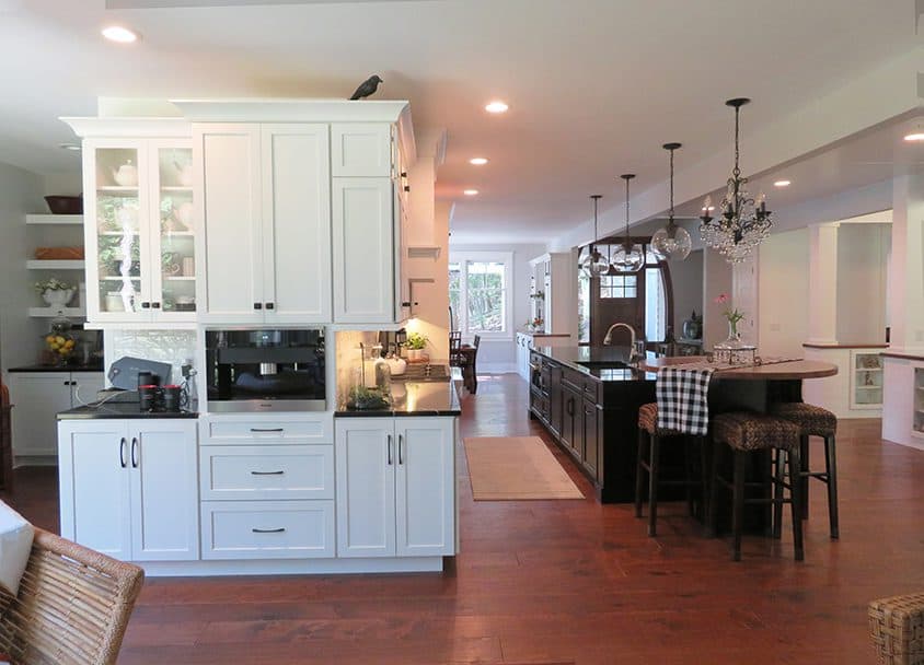Spacious modern kitchen with white cabinetry and central island.