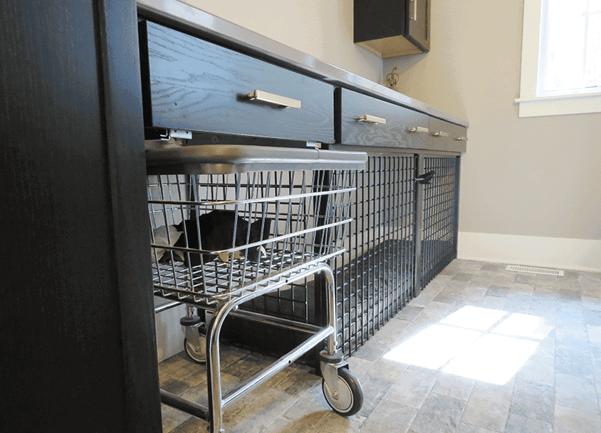 Pet door installed in black cabinetry for easy pet access.