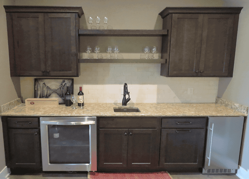 Modern kitchen with dark wood cabinets and granite countertops.