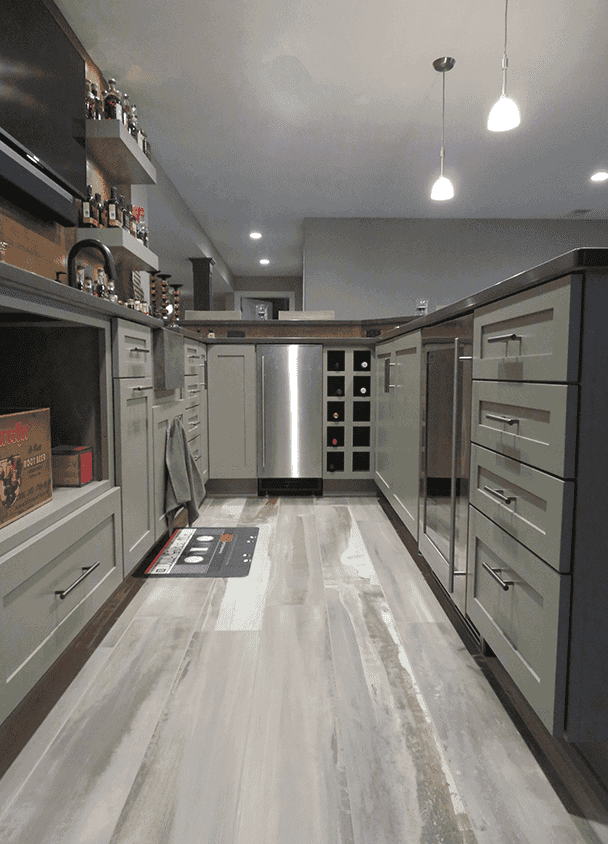 Contemporary kitchen with gray cabinets, stainless appliances, and pendant lighting.