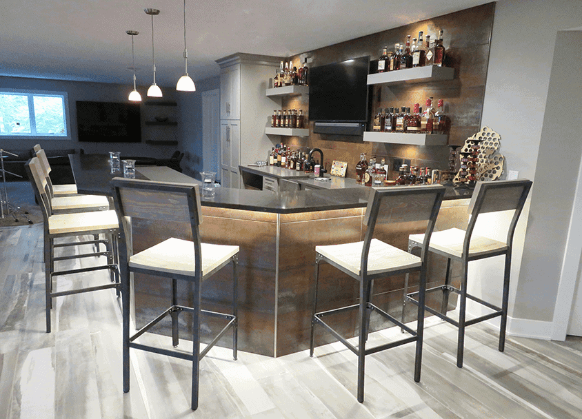 Contemporary home bar with high chairs and liquor shelves.