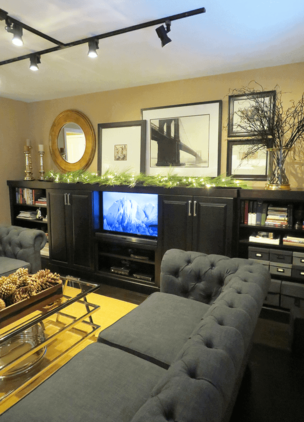 Contemporary living room with wall art, black cabinet, and gray sofa.
