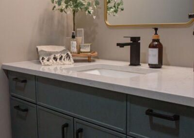 Contemporary bathroom vanity with marble countertop and black fixtures.