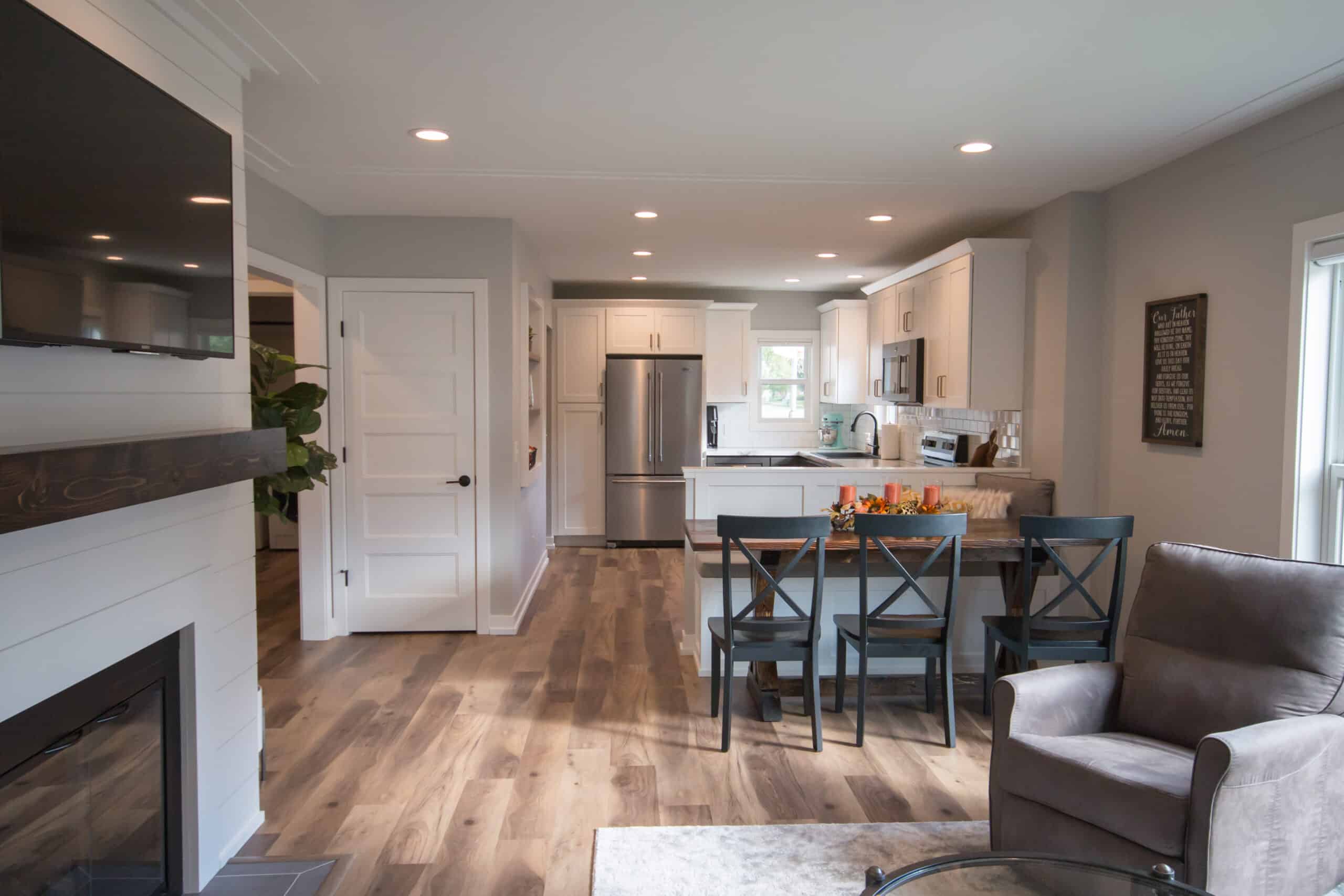 Open-concept kitchen with stainless steel appliances and dining area.