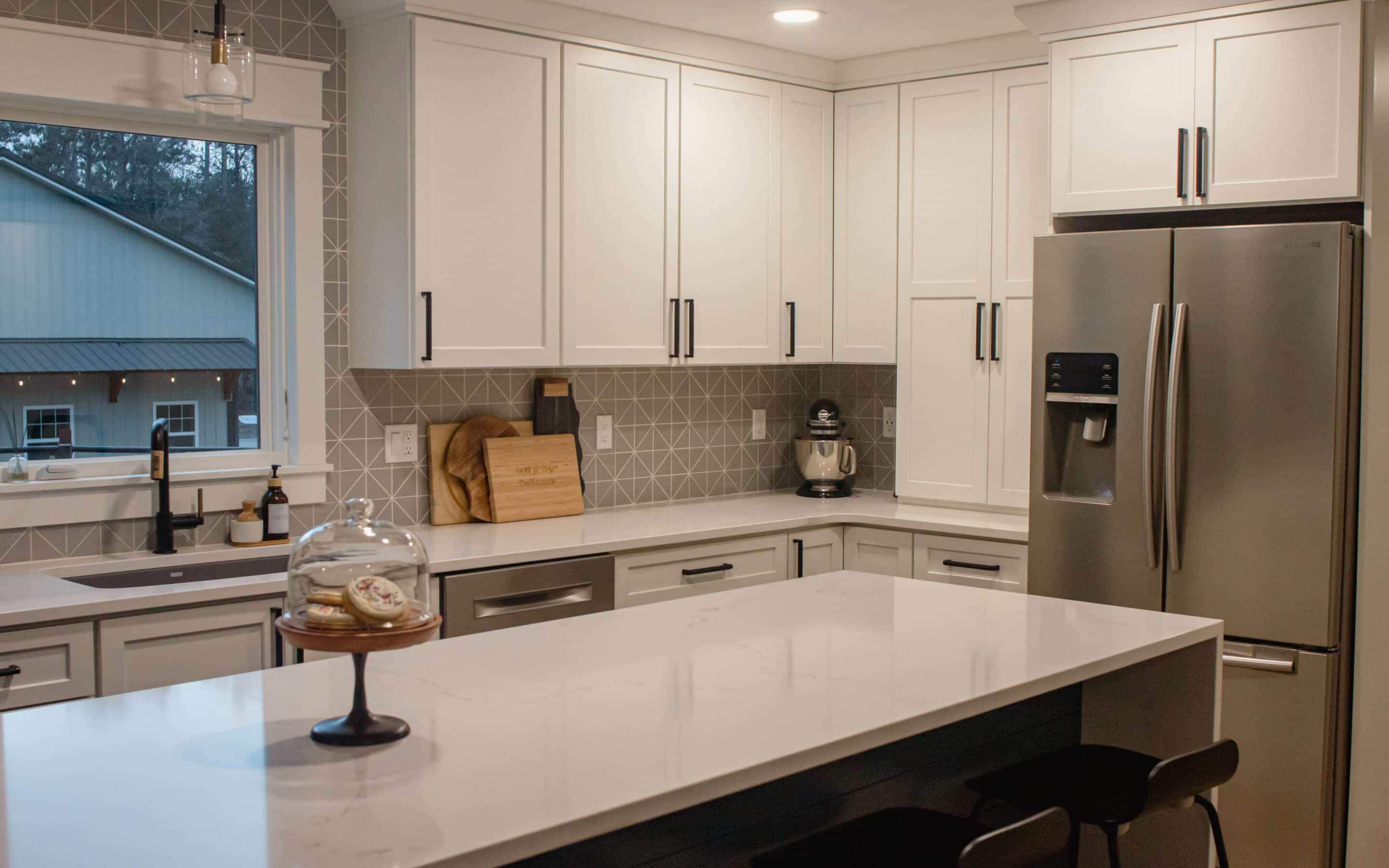Contemporary kitchen with white cabinets and stainless steel appliances.