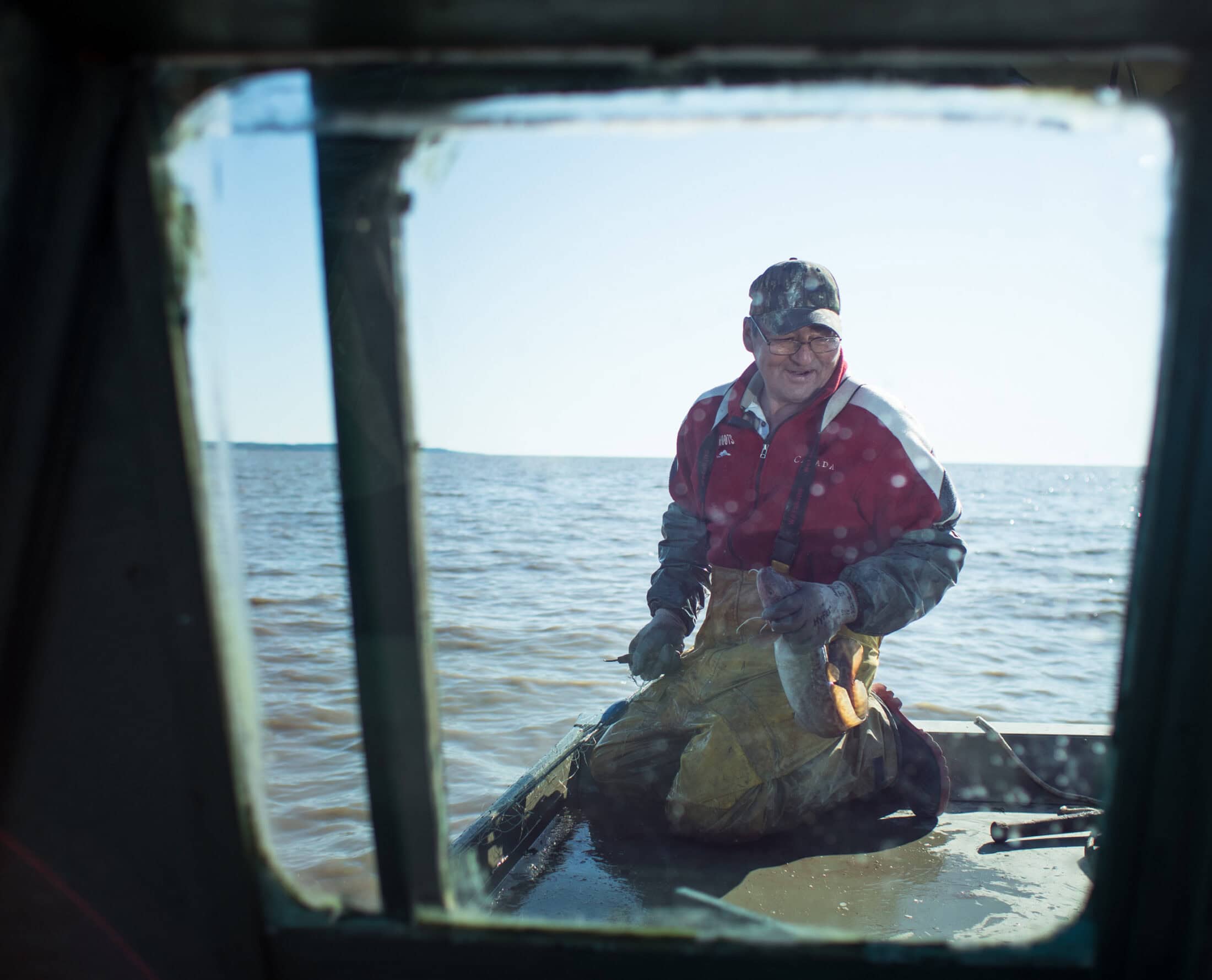 Robert Grandjambe checking his nets on Lake Athabasca. Fort Chip, AB.